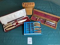 Complete lot arranged on a green cloth with all sets and the wooden knife block visible.