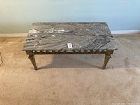 Front and side view of the Italian wood carved coffee table with marble top, showing the carved legs and marble pattern.
