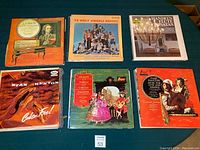 Photo showing nine vinyl record covers including classical, jazz, and blues genres. Visible artists and titles include J.S. Bach, Stan Kenton, Haydn, Handel, and Vivaldi.