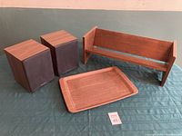 Pair of Wharfdale speakers, wooden tray, and wooden desk-top bookshelf displayed on a green cloth backdrop.