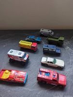 Nine assorted vintage toy cars from various angles on dark surface