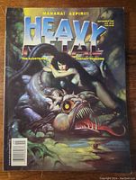 Front cover of Heavy Metal magazine featuring fantasy artwork of a woman on a dragon-like creature with the title and issue date visible.