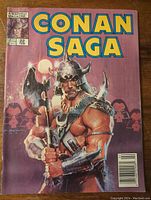 Front cover of Conan Saga volume 1 number 22 featuring Conan warrior with axe and horned helmet against purple background with moon.