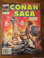 Front cover of the Marvel Conan Saga comic magazine, issue 60, showing Conan with sword and shield and female character on rocky terrain with glowing orb in background.
