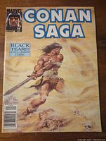 Front cover photo showing Conan wielding a sword under title Conan Saga with issue details and bar code.