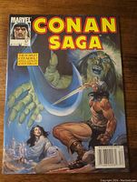 Cover photo of Conan Saga magazine volume 1 number 57 showing illustrated artwork of Conan fighting a monster with a woman in white on the floor.