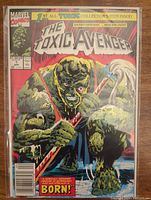Front cover of The Toxic Avenger #1 comic book showing the deformed green creature with a mop and the comic title.