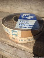Photo of a 3M Safety-Walk anti-slip tape roll with label indicating 1 inch by 60 feet black medium grade tape, new condition.