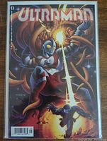 Front cover of Ultra Comics Ultraman #1 showing Ultraman fighting a tentacled monster with a beam attack, in a protective bag.