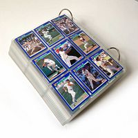 Binder with pages of 1991 Score baseball cards, showing multiple color player cards in nine-pocket plastic sleeves