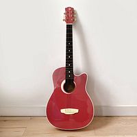 Full front view of the 3/4 size red Luna Aurora Rosebud acoustic guitar with cutaway body shape.