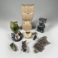 Photo showing 3 owl stone figurines and 7 pieces of owl-themed jewelry arranged on white background, detailed views of colors and materials