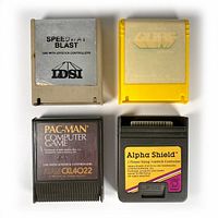 Four vintage Atari 400/800 game cartridges displayed together showing varied colors and labels