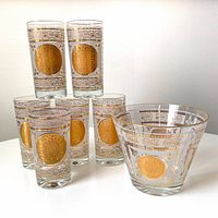 Photo of all six highball glasses alongside the ice bucket showing gold Maya calendar medallion decoration on each item.