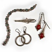 Complete lot layout showing green stone bracelet, horse head tie clip, orange-red stone earrings, and silver hoop earrings arranged on white background.