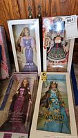 Four boxed Barbie dolls including February Amethyst, Aquarius, Oktoberfest and Dolls of the World Barbies in original packaging.