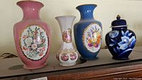 Four vases on display including two Franklin limited edition vases and two other decorative vases.