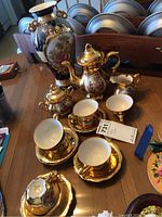 Overall lot view: Limoges vase, coffee pot, sugar bowl with lid, creamer, chip dish, cups and saucers