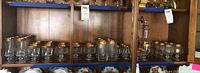 Full cabinet view showing decanter at right and assortment of stemware on shelves
