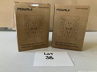 Two boxed Powaui power bars labeled Model AHR-508, showing packaging with outlet and USB port layout.
