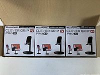 Three boxed Bell & Howell Clever Grip Pro 3.0 holders placed side by side on a flat surface.