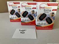 Three closed boxes of HeatMatez CozyClasp electric hand warmers showing front packaging with 2pcs label