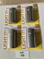 Set of four brand new Light It! motion activated LED path lights in packaging showing front of each unit and packaging details.
