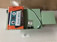 Amazon Fire HD 10 tablet box stacked on Uncaged Ergonomics laptop tray with USB cable and accessory bag on top