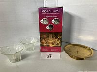 Photo showing the box of the RosaLumi Blooming Crystal Table Lamp and two clear glass candleholders. The box highlights 3 brightness levels.