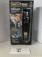 Front view of boxed Bell + Howell VacuTrim rechargeable beard trimmer, shows branding, key features like built-in vacuum, 20 length settings, vacuum suction power and product image.