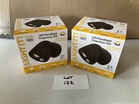 Two boxed Light It! brand LED floodlights for outdoor use, new condition, unopened packaging.