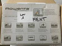 Front of the box showing Rowenta Pro Compact branding and features including powerful vertical steam, easy to use, compact, 1400W power, self-clean system, and safety features.