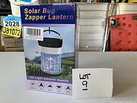 Front of box showing product photo and brand name 'Solar Bug Zapper Lantern'.