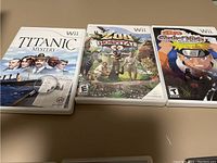 Photo of three Wii game cases: Titanic Mystery, Zoo Hospital, Naruto Clash of Ninja, showing front covers.