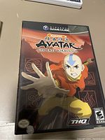 Front cover of Avatar The Last Airbender GameCube game case showing cover art with Aang reaching forward. Rated E10+. THQ and Nickelodeon branding visible.