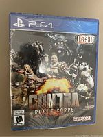 Photo of the sealed Contra Rogue Corps PS4 game case showing front cover art and rating.