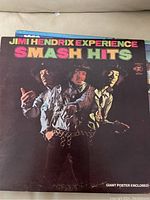 Front cover of Jimi Hendrix Experience Smash Hits album showing the band members and colorful album title.