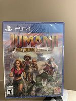 Front cover of sealed Jumanji The Video Game for PS4 showing characters and game title