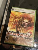 Front cover of Samurai Warriors for Xbox 360 in sealed case showing cover art, title, and rating.