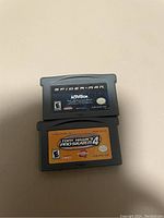 Photo showing two Game Boy Advance cartridges: Spider-Man and Tony Hawk's Pro Skater 4.