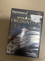 Front cover of the Star Trek Encounters PlayStation 2 game case showing the starship and branding.