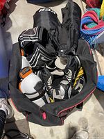 Photo of CCM hockey pants, gloves, shin guards, and Bauer skates inside a bag.