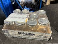 Top view of Bernardin mason jars set in original box, some jars missing and box worn.