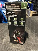 Side view of the Motomaster Eliminator 12V 7A/1A Precision Series Battery Charger box showing product features and specifications.