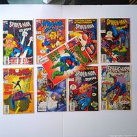 Nine Spider-Man 2099 comic book issues laid out flat, showing front covers in protective sleeves with backboards.