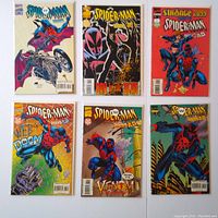 Overview of six Spider-Man 2099 comic books in clear protective sleeves, arranged on a surface showing cover artwork including Spider-Man in various action poses and themes.