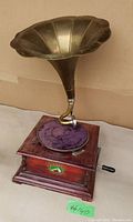 Front and top view showing brass horn, purple turntable mat, wooden base, crank handle