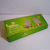 Closed green packaging box with product branding indicating wireless control, full spectrum light, energy efficiency.