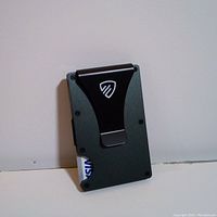 Slim metal RFID blocking wallet with black money clip holding a visible card.