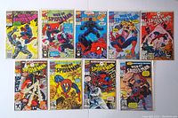 A group photo showing 9 Web of Spider-Man comics laid out flat in two rows with colorful covers depicting Spider-Man in dynamic action scenes